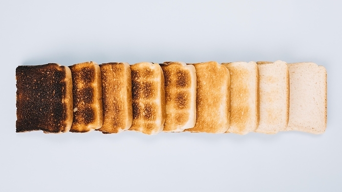Top view bread slices varying stages toasting arranged row white background, by Oleksandr Latkun