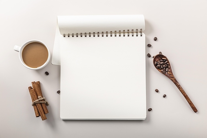 Top view notebook with coffee cup cinnamon sticks, by Oleksandr Latkun