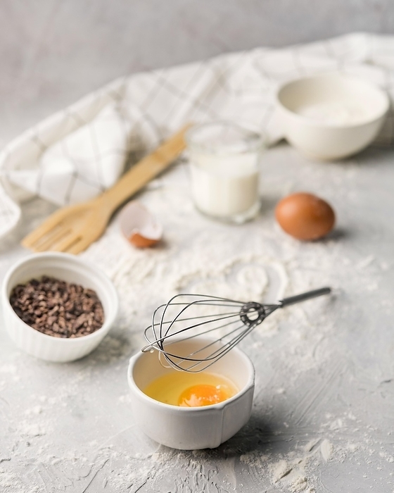 Close up whisk with egg baking flour table, by Oleksandr Latkun