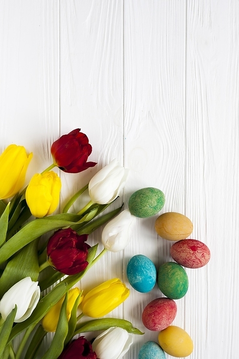 Colored eggs near tulips, by Oleksandr Latkun