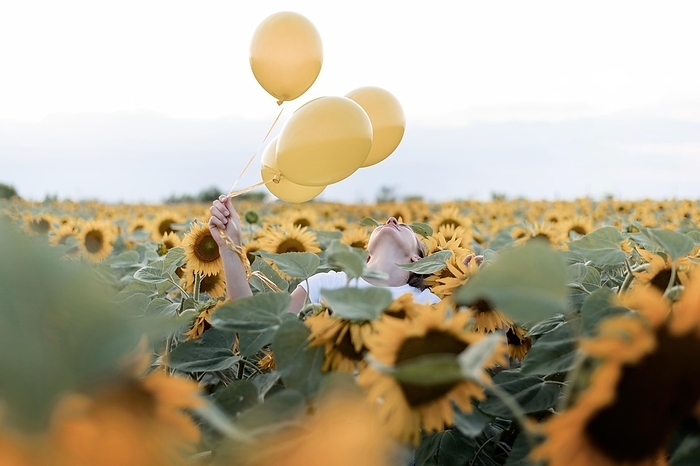 Woman holding balloons sunflower field, by Oleksandr Latkun
