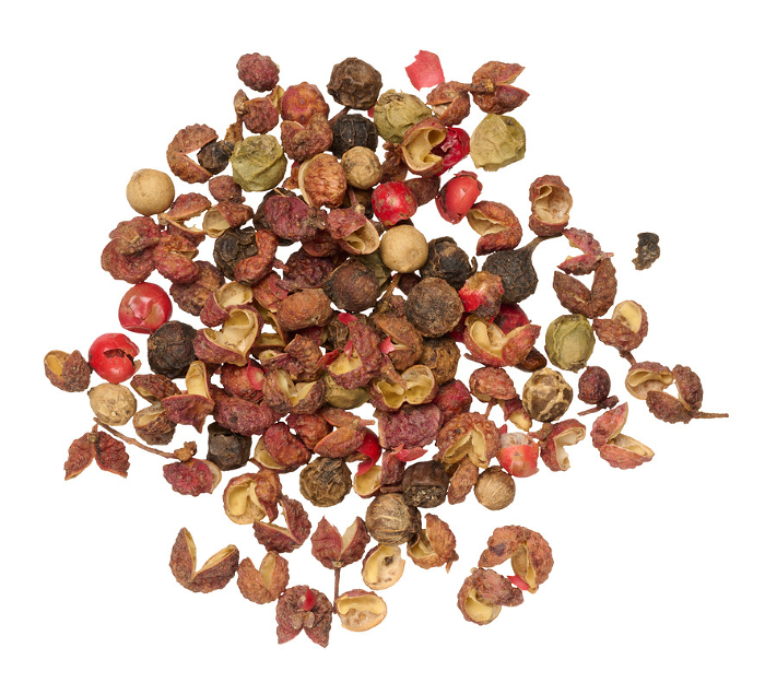 Mixture of red and black peppercorns on isolated background, top view Mixture of red and black peppercorns on isolated background, top view