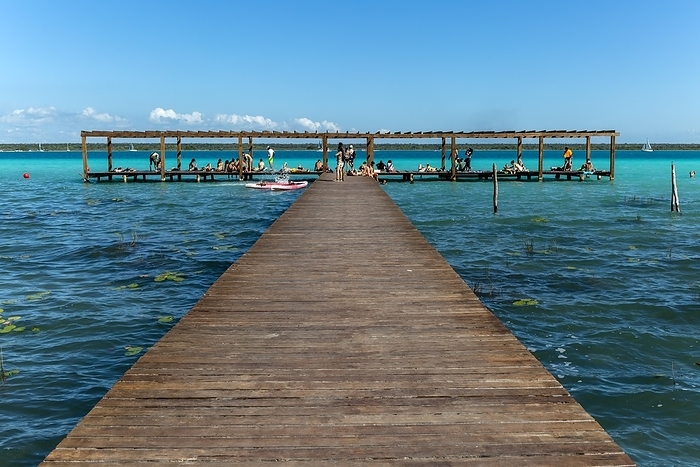 Mexico People sitting on woooden jetty pier by waterside, Lake Bacalar, Bacalar, Quintana Roo, Yucatan Peninsula, Mexico, Central America, by Ian Murray