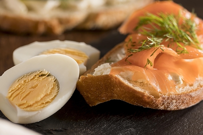 Close up sandwich slate with salmon hard boiled egg, by Oleksandr Latkun