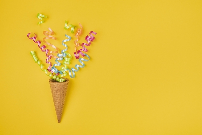Confetti ice cream cone with copy space yellow background, by Oleksandr Latkun