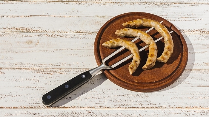 Fork with roast sausages platter, by Oleksandr Latkun