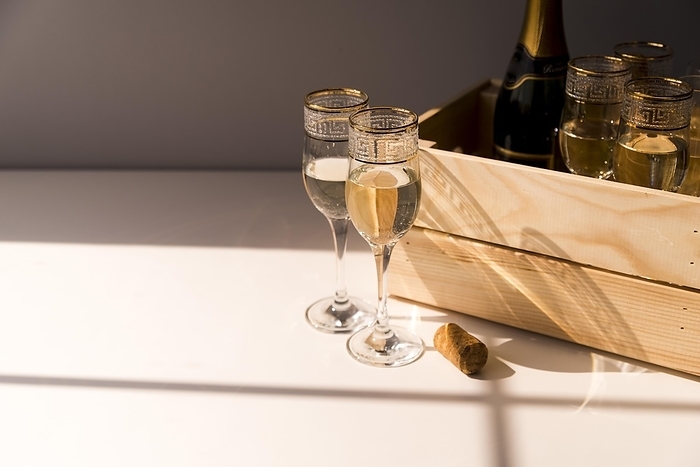 Glass wine champagne wooden crate white table, by Oleksandr Latkun