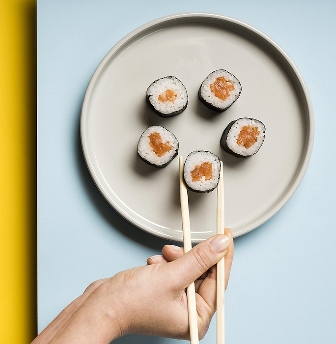 Minimalist plate with sushi rolls chopsticks, by Oleksandr Latkun