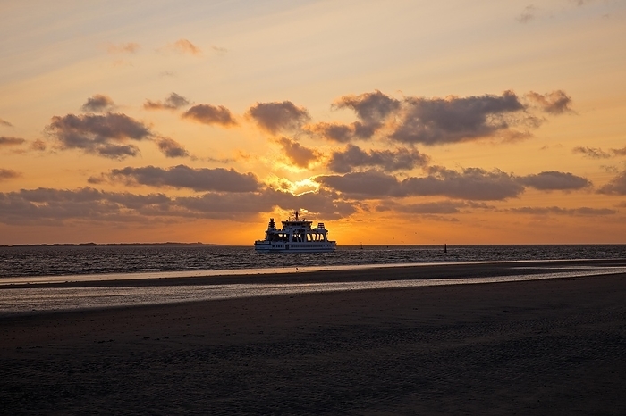 Germany Mudflat landscape with setting sun and the ferry Frisia, Norderney Island, North Sea, East Frisia, Lower Saxony, Germany, Europe, by Stefan Ziese