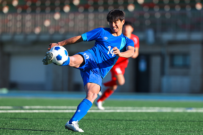 Japanese soccer player hitting a volley shot