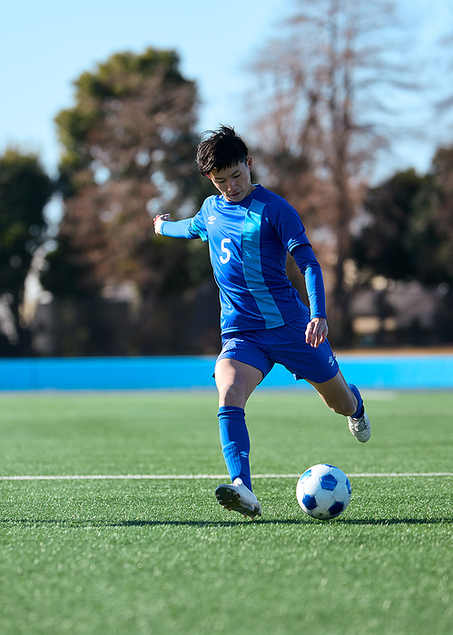 Japanese soccer player taking a free kick