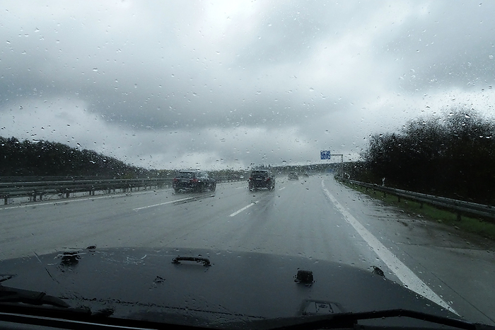 Driving a car in the rain on the highway Driving a car in the rain on the highway, by Zoonar S.Werner Ney