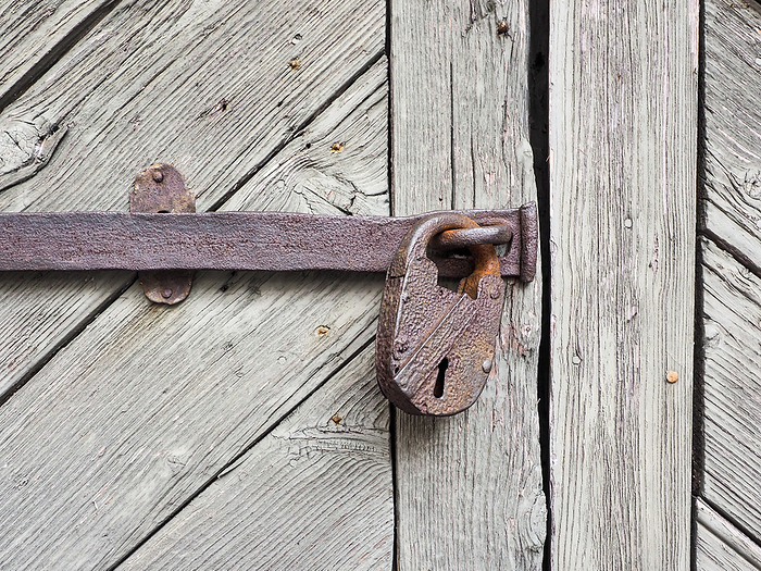 Rusty padlock at wooden door Rusty padlock at wooden door, by Zoonar Katrin May