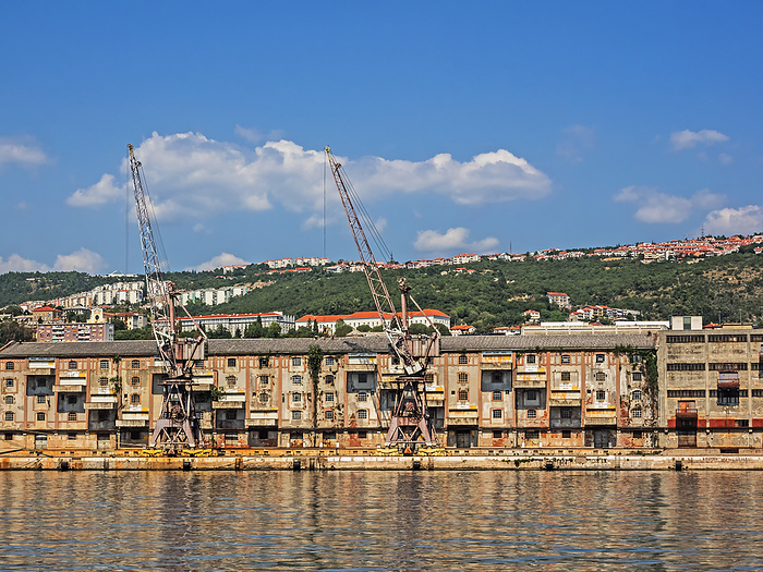 Old warehouse and cranes in the port of Rijeka, Croatia Old warehouse and cranes in the port of Rijeka, Croatia, by Zoonar Katrin May