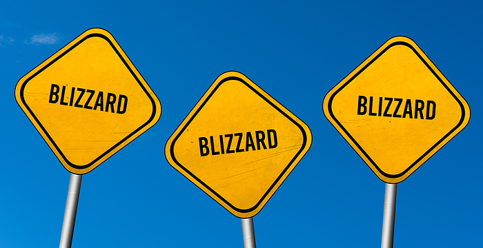 blizzard   yellow signs with blue sky blizzard   yellow signs with blue sky, by Zoonar Markus Beck