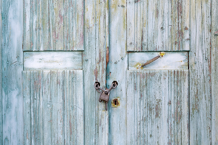 Wooden planks with flaked paint and padlock Wooden planks with flaked paint and padlock, by Zoonar Harald Biebel