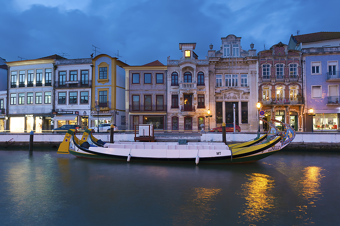 Moliceiro boats docked and Art Nouveau style buildings, Aveiro, Portugal Moliceiro boats docked and Art Nouveau style buildings, Aveiro, Portugal, by Zoonar Francisco Jav