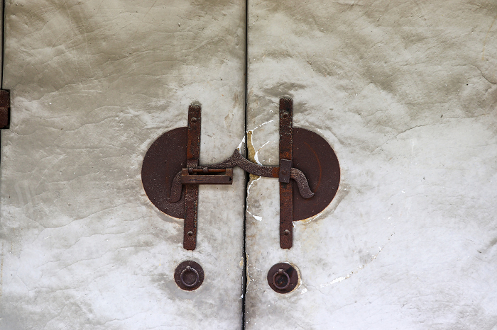 White door and rusty key of an old storehouse