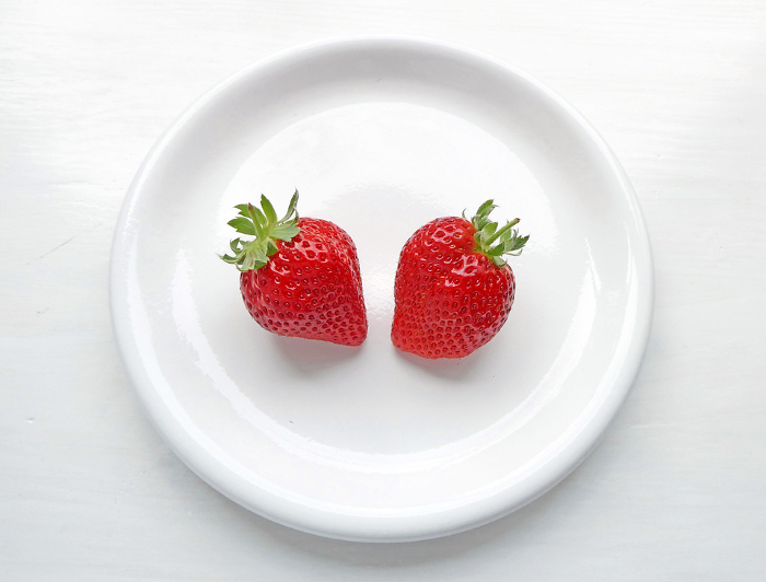 Photo of freshly picked strawberries and a white plate