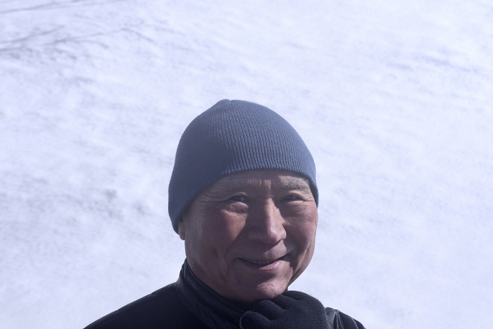 Senior man smiling with snow in the background