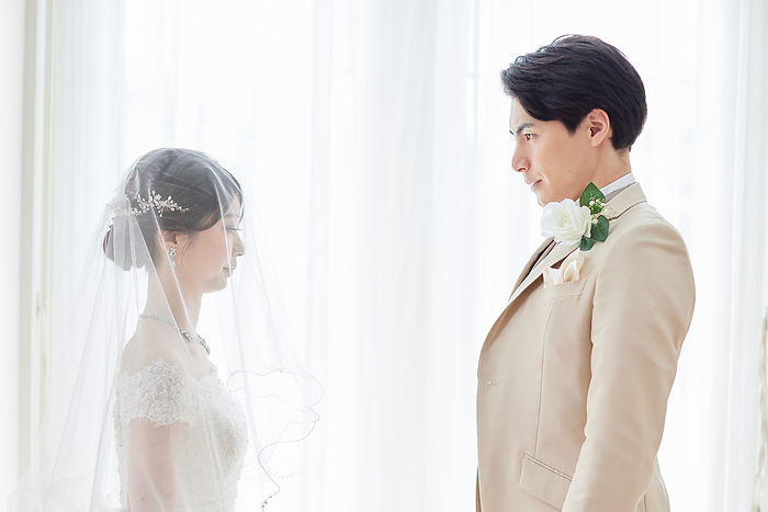 Japanese bride and groom facing each other