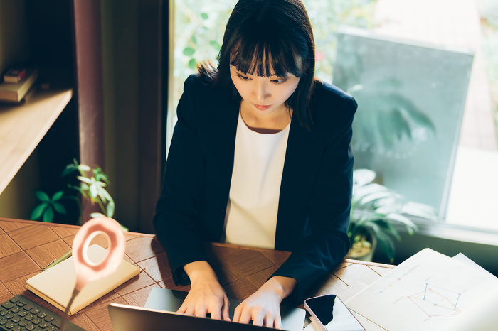 Japanese businesswoman at her desk (People)