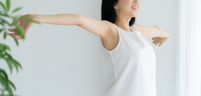 Young Japanese woman in white stretching (People)