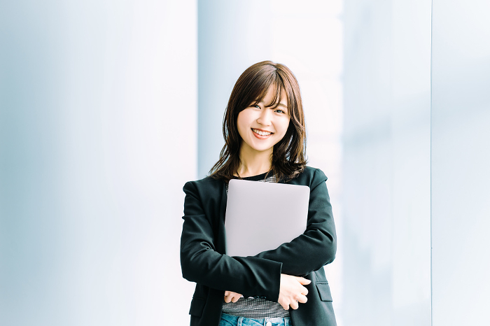 Smiling Japanese businesswoman with laptop computer (Female / People)