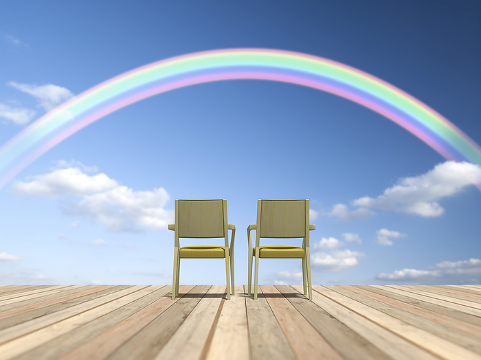Chairs lined up on a wooden deck and a rainbow overhead
