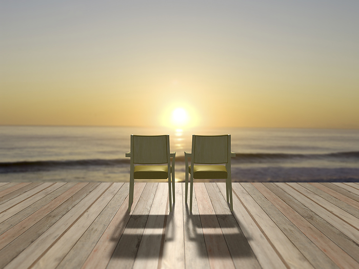 Two chairs overlooking the sea at sunrise