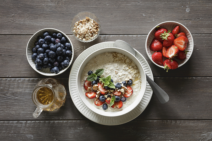 Studio shot of bowl of porridge with blueberries and strawberries
