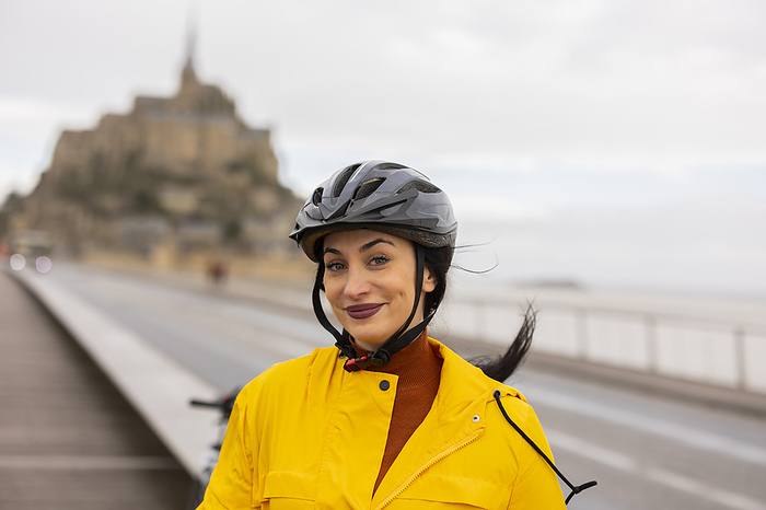 Smiling woman with cycling helmet on street