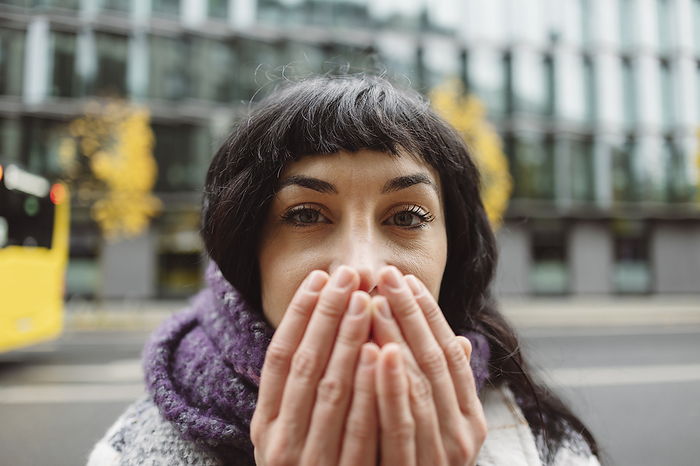 Woman covering mouth with hands