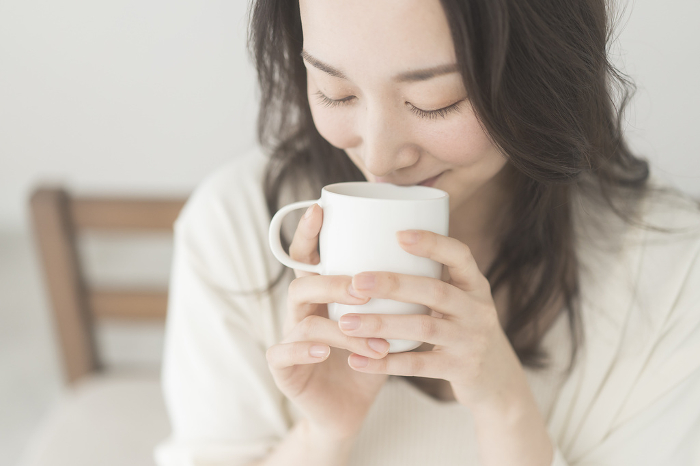 Japanese woman drinking a hot drink in the morning (People)