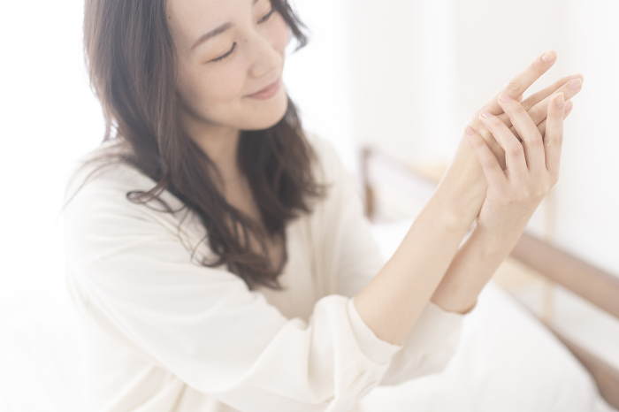 Japanese woman giving hand care (People)