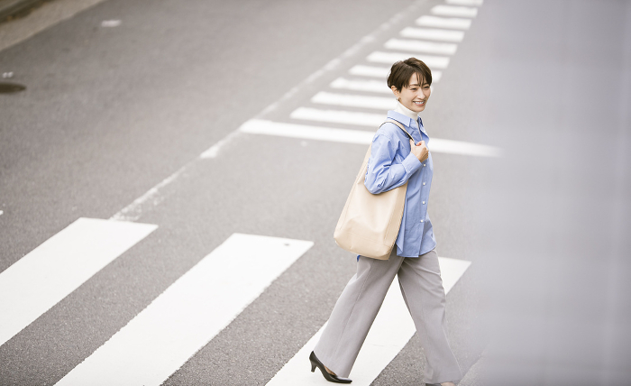 Japanese woman crossing a pedestrian crossing (People)