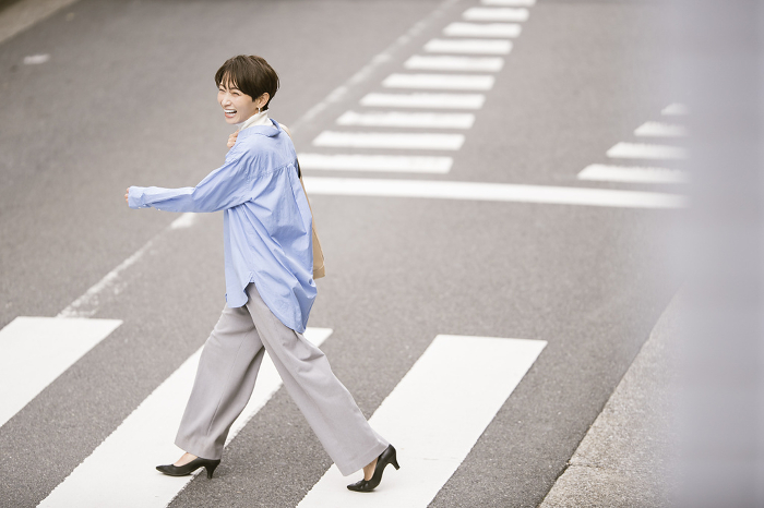 Japanese woman crossing a pedestrian crossing (People)
