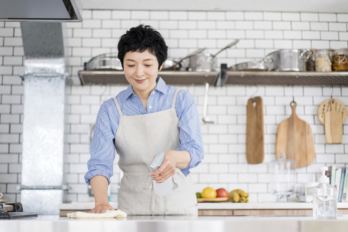 A person wiping down the kitchen (Female / Japanese)