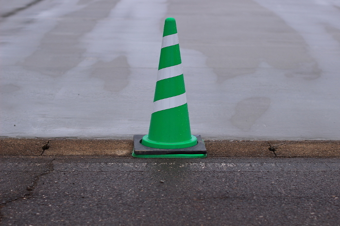 Color cones protecting freshly paved site