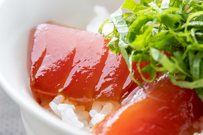 A close-up of a bowl of rice topped with pickled tuna.