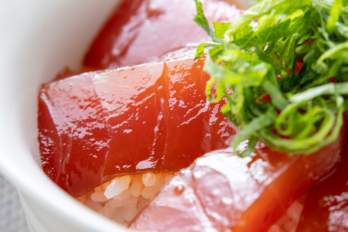 A close-up of a bowl of rice topped with pickled tuna.