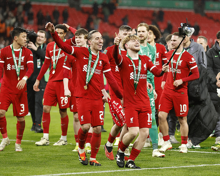 Chelsea v Liverpool   Carabao Cup Final Kostas Tsimikas and Harvey Elliott of Liverpool celebrates with camera stick after winning the Carabao Cup Final match between Chelsea and Liverpool at Wembley Stadium on February 25, 2024 in London, England.   WARNING  This Photograph May Only Be Used For Newspaper And Or Magazine Editorial Purposes. May Not Be Used For Publications Involving 1 player, 1 Club Or 1 Competition Without Written Authorisation From Football DataCo Ltd. For Any Queries, Please Contact Football DataCo Ltd on  44  0  207 864 9121