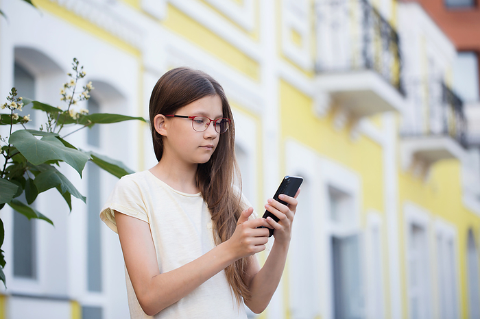 A teenage girl communicates through a smartphone, Bila Tserkva, Kyiv Oblast, Ukraine, by Cavan Images / Iuliia Malivanchuk