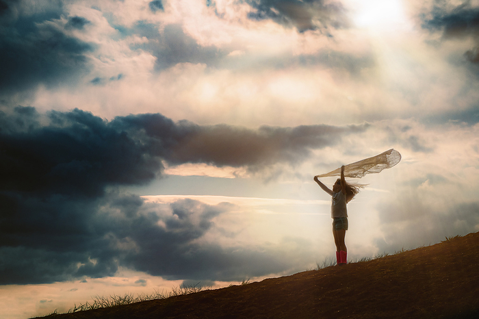 Girl holding scarf on hill, Tulsa, Oklahoma, United States, by Cavan Images / Kristen Ryan