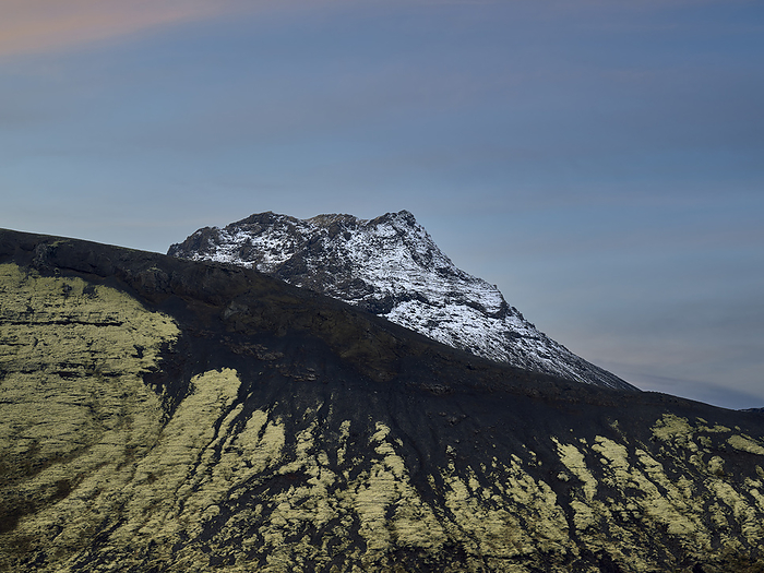 Mountain ridge with snowy peak under cloudless blue sky, Kópavogur, Iceland, by Cavan Images / Oscar Bjarnason