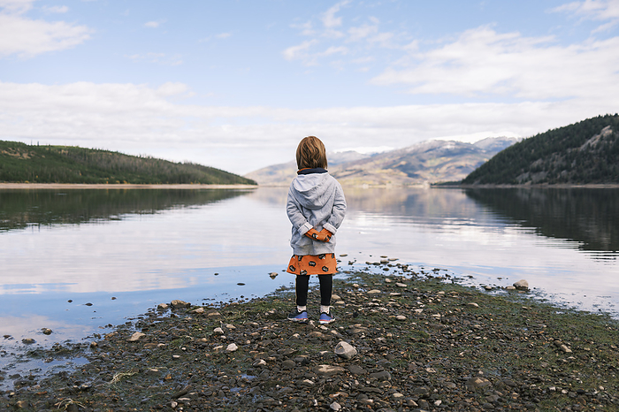 Young girl enjoying a tranquil moment at the lake, United States, Colorado, Silverthorne, by Cavan Images / Patrick Lienin