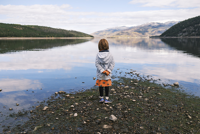 Red-haired girl enjoying a tranquil moment, United States, Colorado, Silverthorne, by Cavan Images / Patrick Lienin