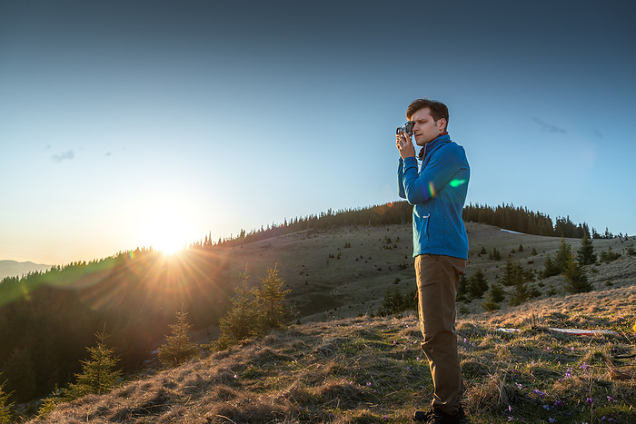 Young Man Photographing a Beautiful View at Sunset, Ivano-Frankivsk, Ivano-Frankivsk Oblast, Ukraine, by Cavan Images / Artur Abramiv