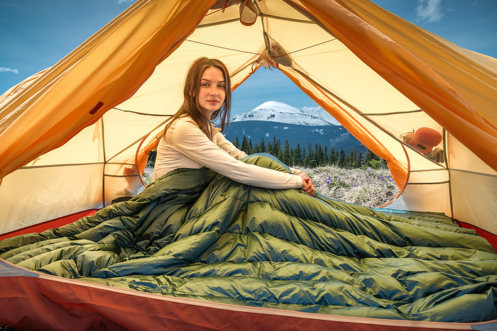 Young Woman Sitting in Tent in the Mountains, Ivano-Frankivsk, Ivano-Frankivsk Oblast, Ukraine, by Cavan Images / Artur Abramiv