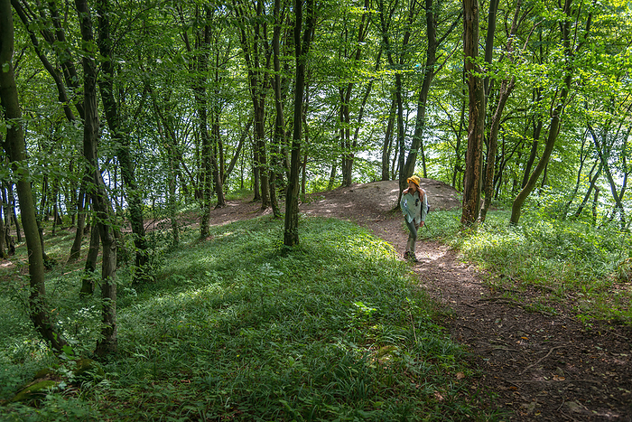 Young Woman Walking in a Forest on a Sunny Day, Novyi Rozdil, Lviv Oblast, Ukraine, by Cavan Images / Artur Abramiv